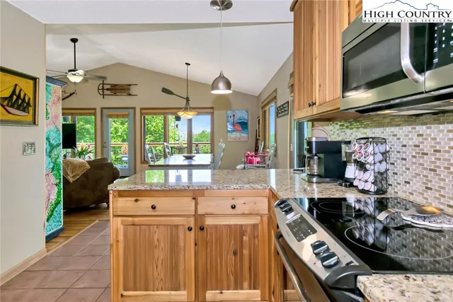 a living room with furniture a fireplace and a chandelier