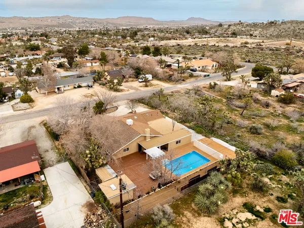 an aerial view of residential houses with outdoor space