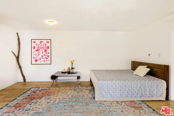 a bedroom with a bed and a couch