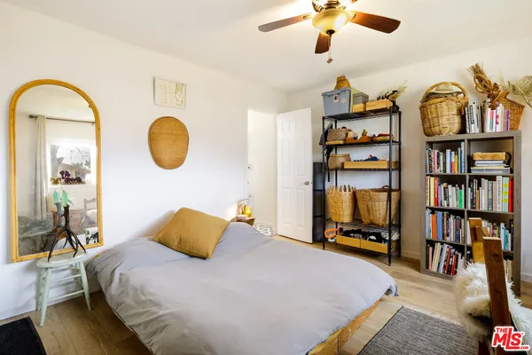 a bedroom with bed and a chandelier