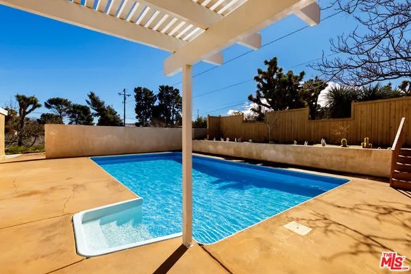 a view of swimming pool with outdoor seating