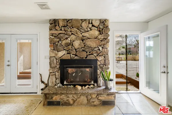 a living room with a fireplace with a flat screen tv