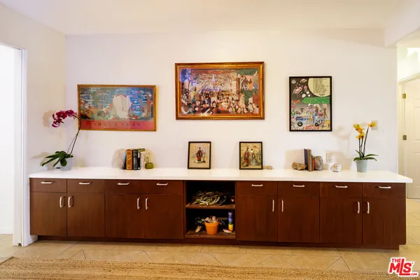 a living room with furniture and wall paintings