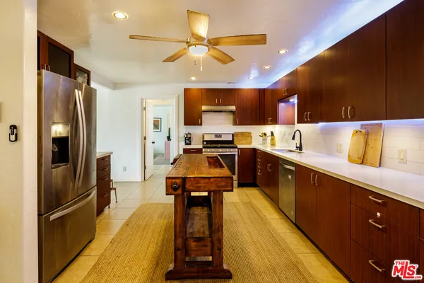 a kitchen with stainless steel appliances a refrigerator and a sink