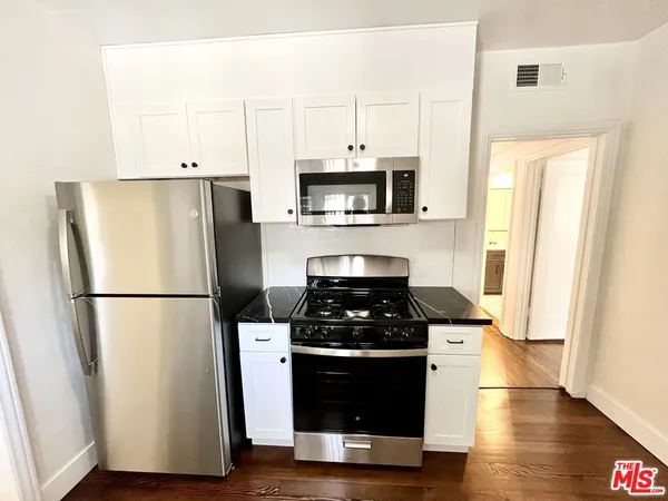 a kitchen with a refrigerator and a stove