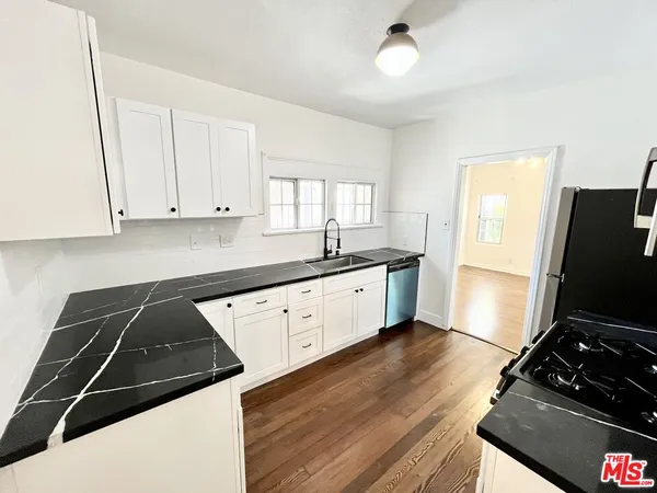 a kitchen with a sink appliances and cabinets