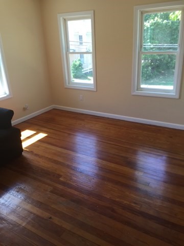 52 Winter Street Taunton, MA 02780 - Photo 13 of 21 an empty room with wooden floor and windows