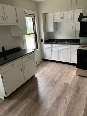 52 Winter Street Taunton, MA 02780 - Photo 2 of 21 a kitchen with granite countertop a sink a stove and cabinets