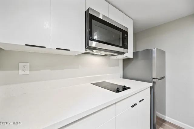 a kitchen with a microwave and a sink