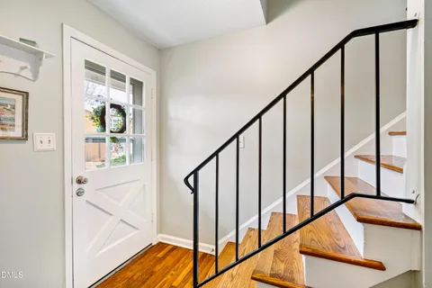 a view of an entryway with wooden floor and door