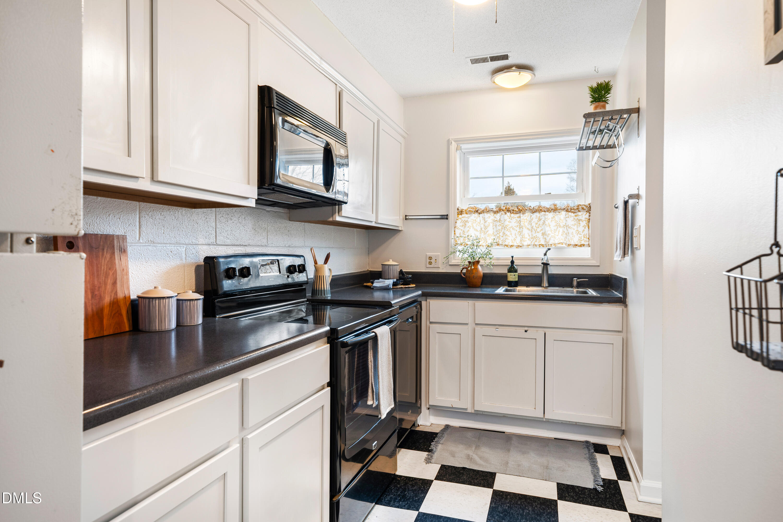 400 Davie Road, Unit 57 Carrboro, NC 27510 - Photo 7 of 28 a kitchen with stainless steel appliances granite countertop a stove a sink and a microwave