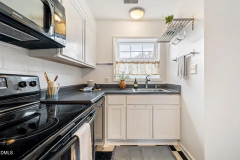 a kitchen with stainless steel appliances granite countertop a sink and a stove