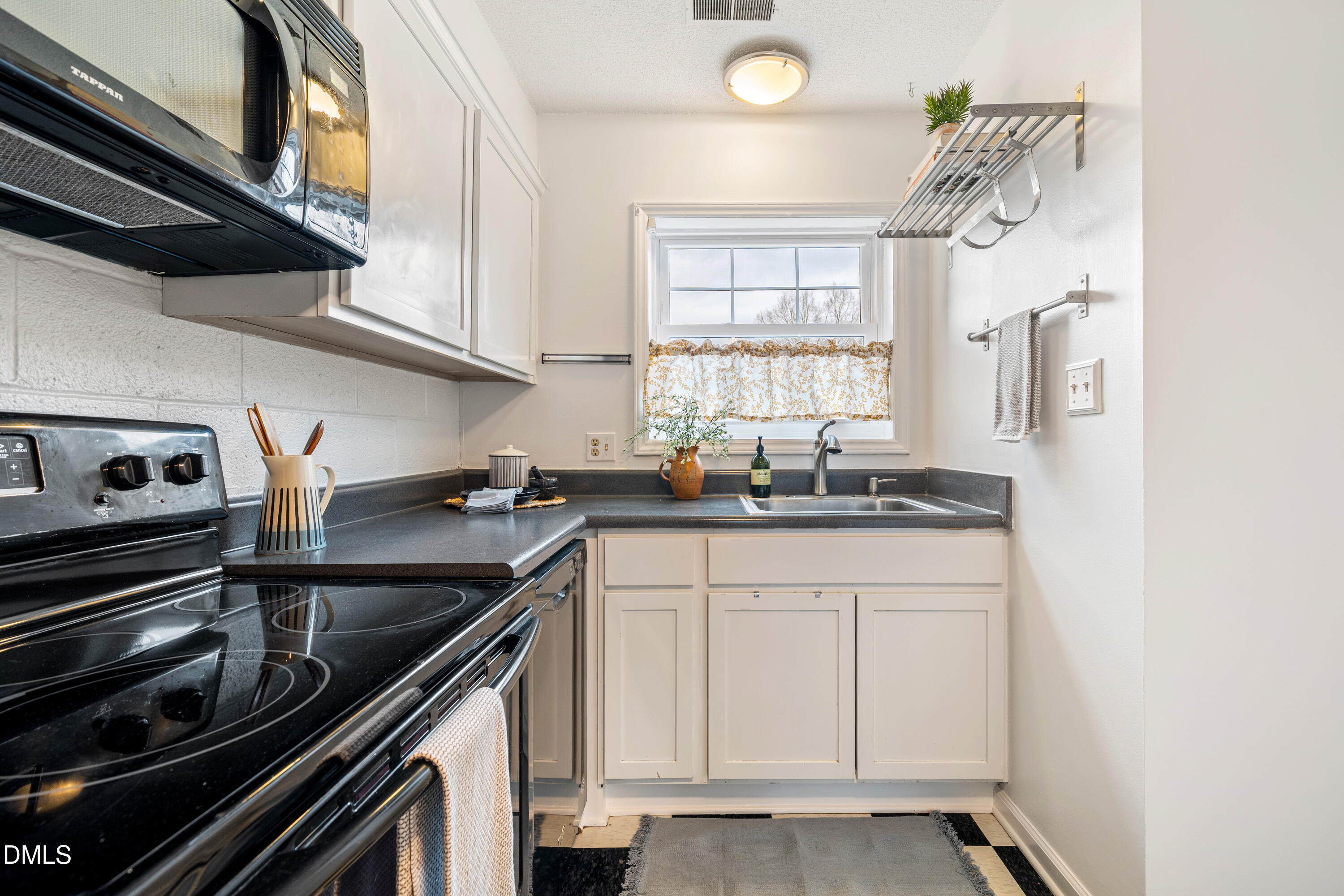 400 Davie Road, Unit 57 Carrboro, NC 27510 - Photo 8 of 28 a kitchen with stainless steel appliances granite countertop a sink and a stove