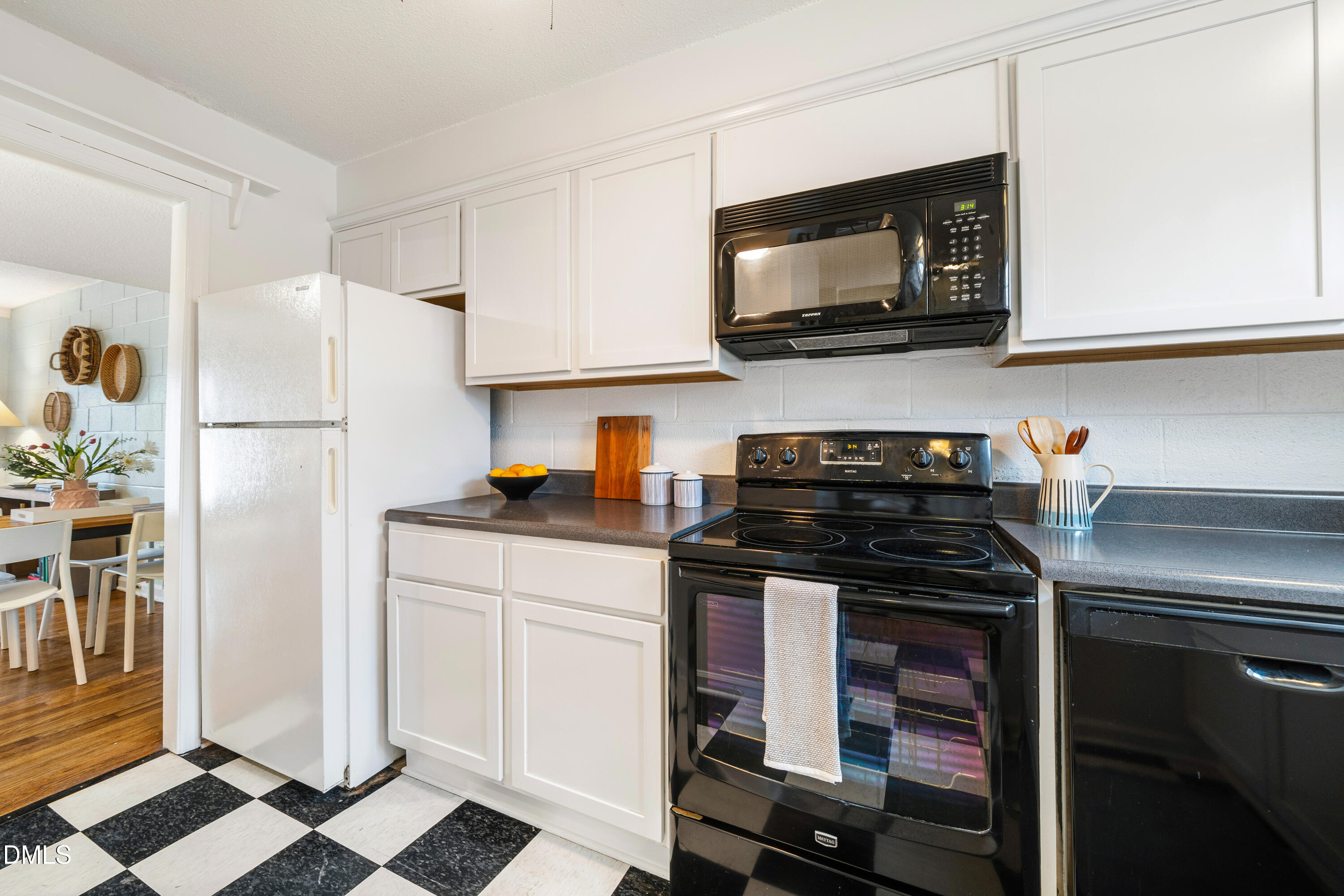 400 Davie Road, Unit 57 Carrboro, NC 27510 - Photo 9 of 28 a kitchen with stainless steel appliances a stove a microwave and a refrigerator