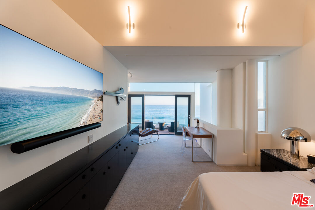 23754 Malibu Road Malibu, CA 90265 - Photo 15 of 59 a living room with furniture and large windows