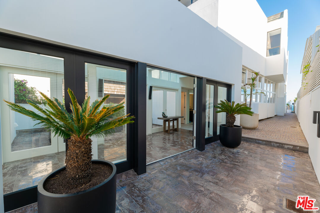 23754 Malibu Road Malibu, CA 90265 - Photo 22 of 59 a vase of flowers sitting on a table in a lobby