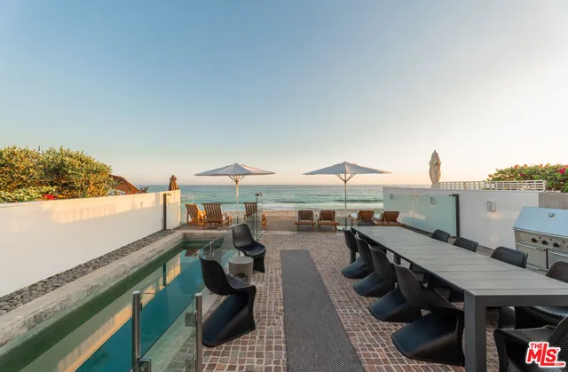 a view of house with swimming pool outdoor seating