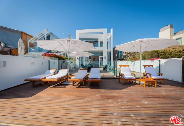 a living room with fireplace furniture and a large window