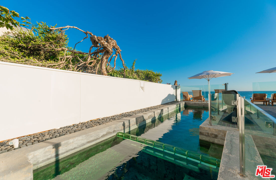 23754 Malibu Road Malibu, CA 90265 - Photo 40 of 59 a view of a swimming pool with a patio
