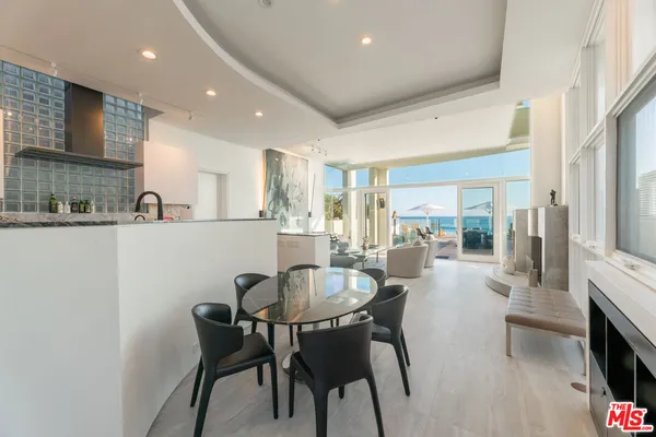 a view of a house with a small yard and large tree