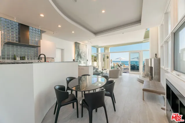 a view of a house with a small yard and large tree