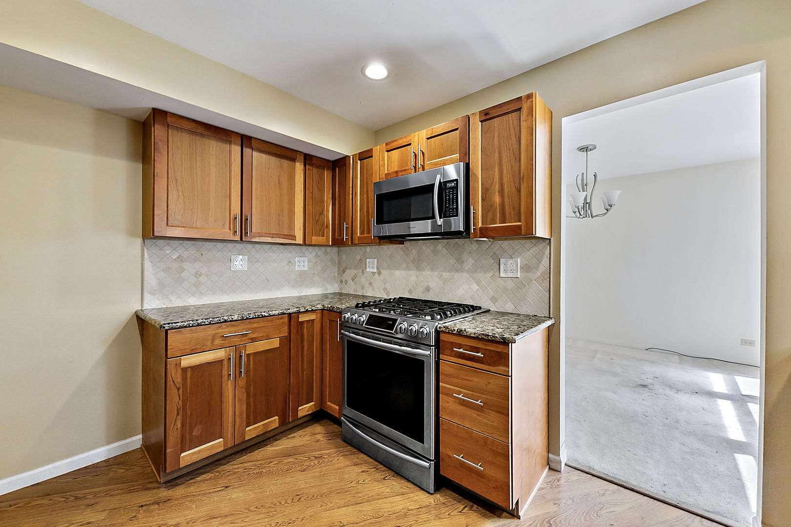 2080 Springside Drive Naperville, IL 60565 - Photo 14 of 31 a kitchen with stainless steel appliances granite countertop a stove and a microwave