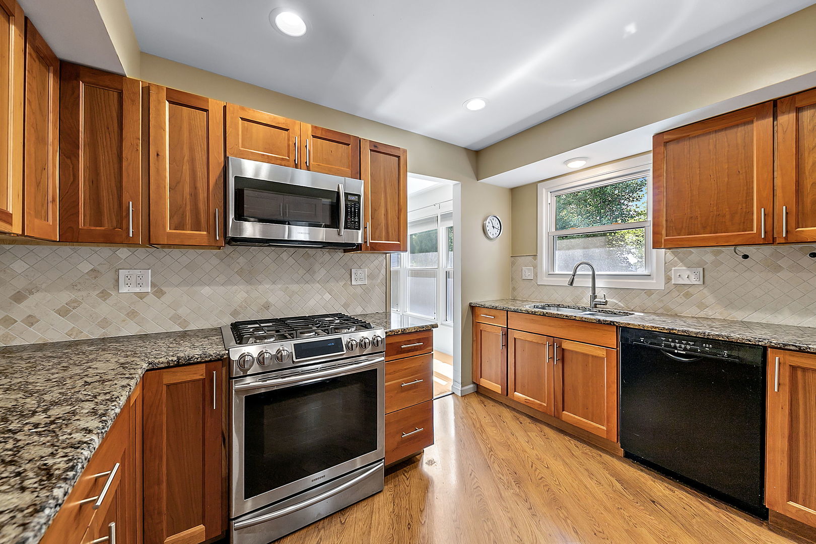 2080 Springside Drive Naperville, IL 60565 - Photo 15 of 31 a kitchen with stainless steel appliances granite countertop wooden cabinets stove top oven and sink