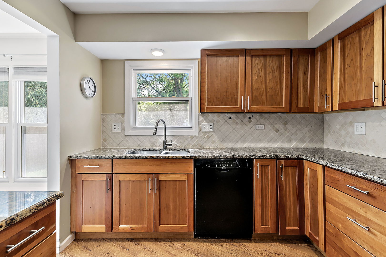 2080 Springside Drive Naperville, IL 60565 - Photo 16 of 31 a kitchen with granite countertop a sink stove and cabinets