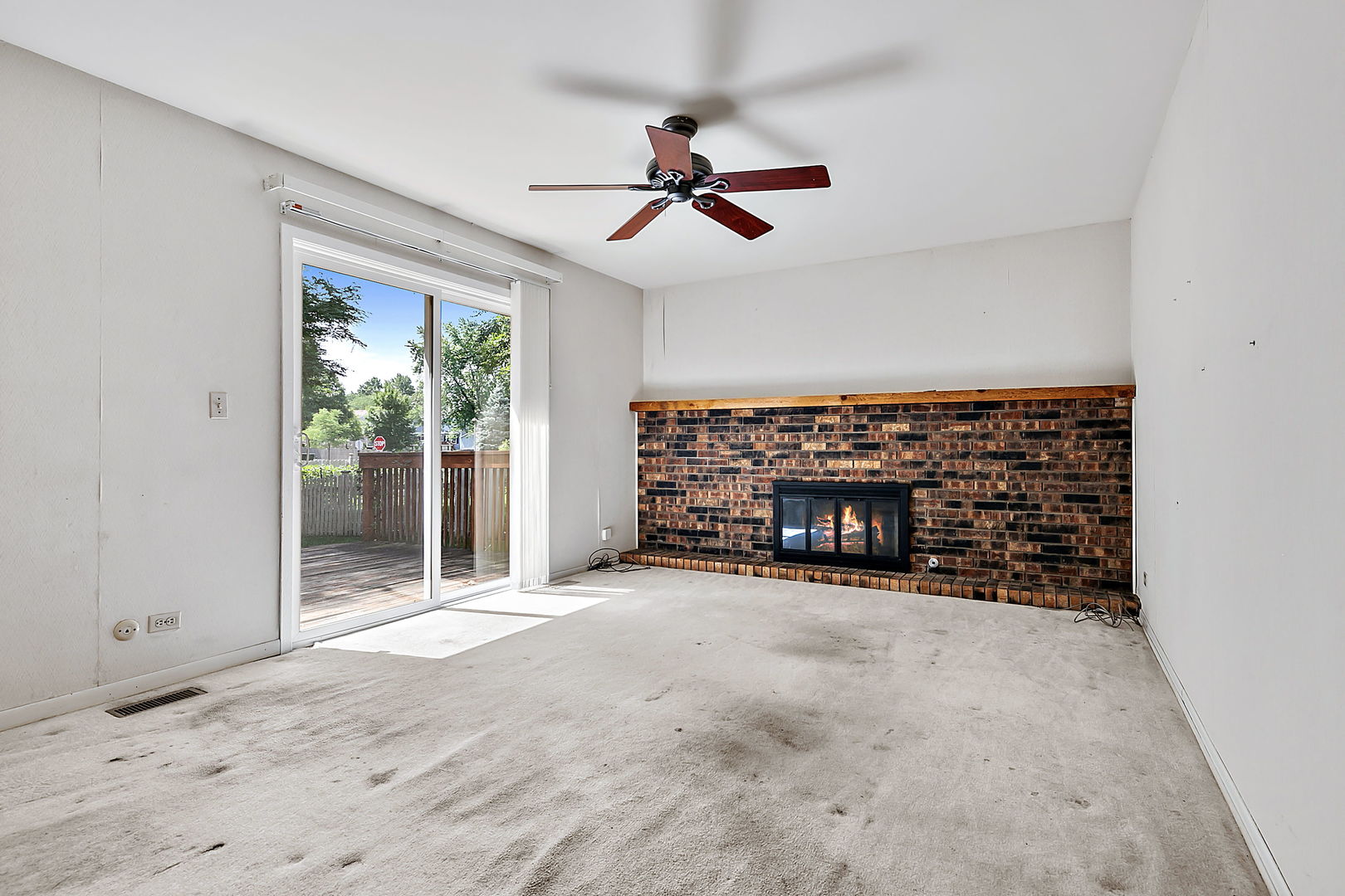 2080 Springside Drive Naperville, IL 60565 - Photo 17 of 31 a view of an empty room with a fireplace and a chandelier