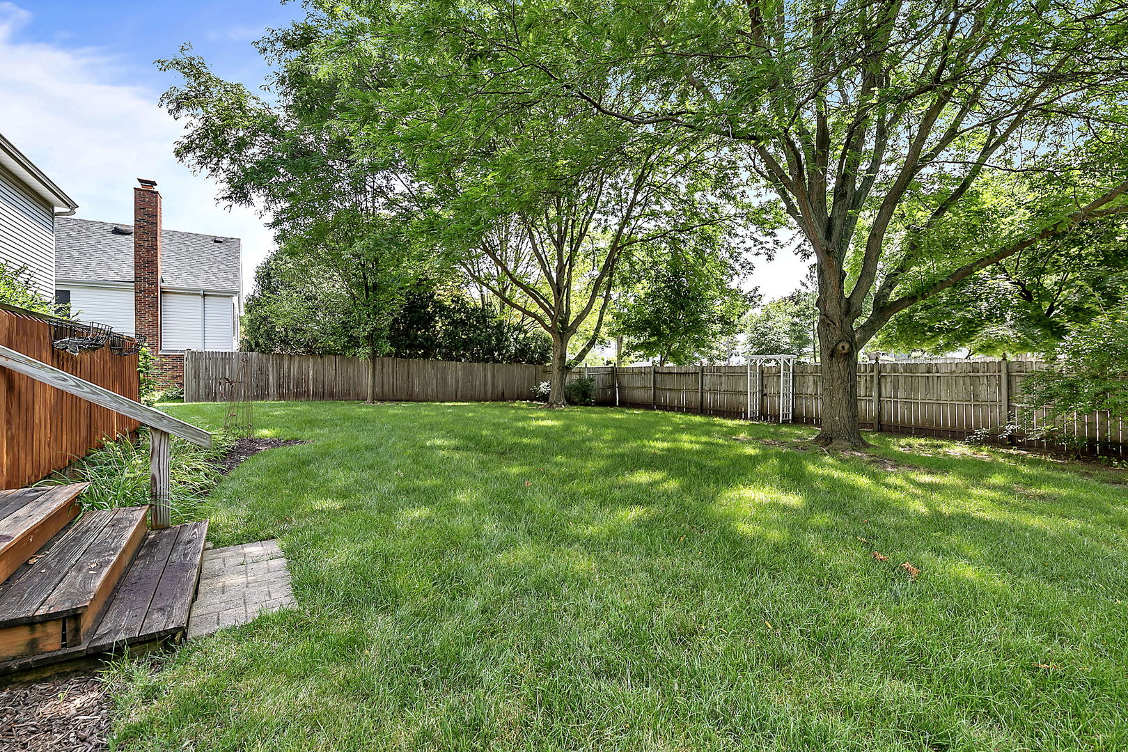 2080 Springside Drive Naperville, IL 60565 - Photo 3 of 31 a view of backyard with wooden fence and large trees
