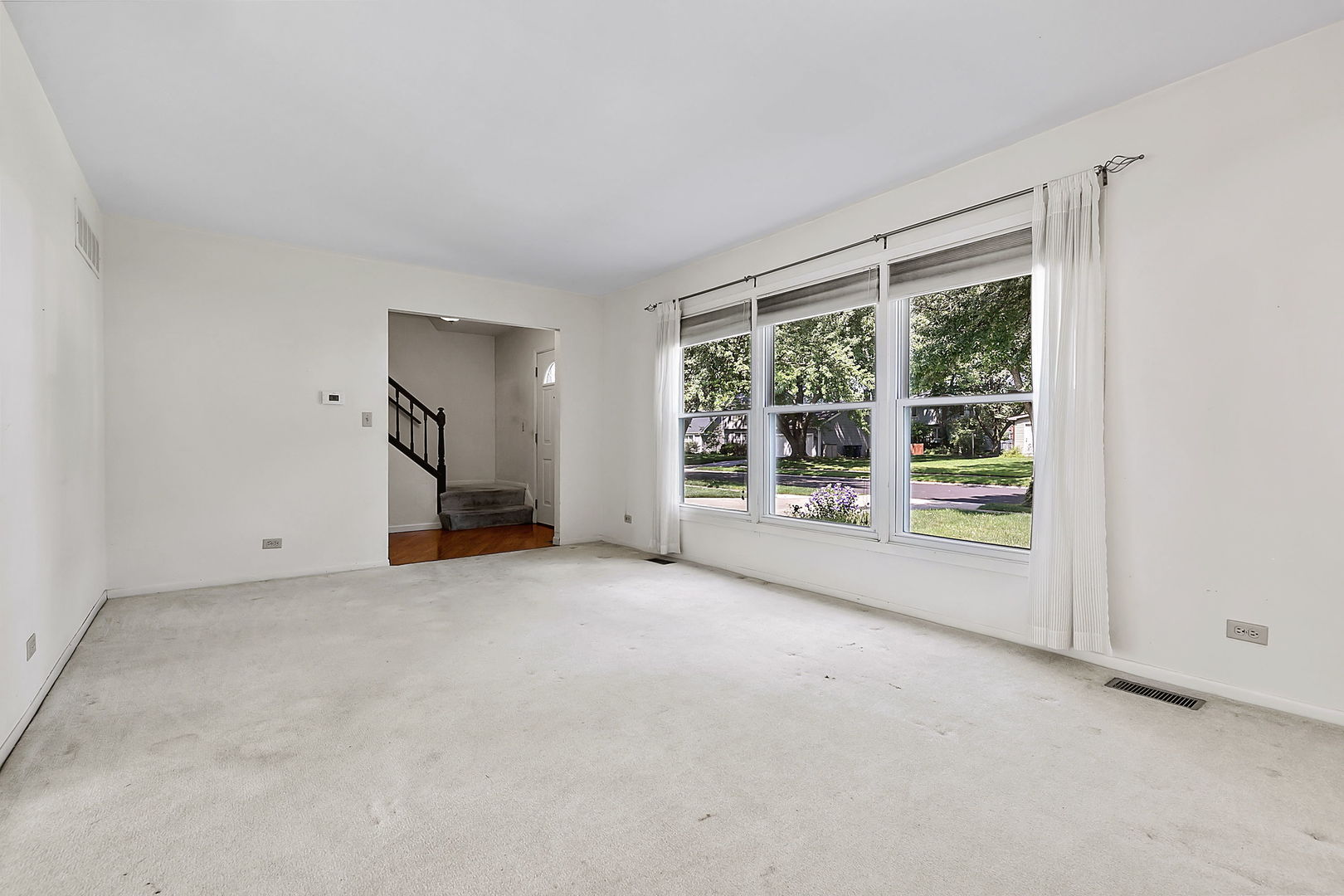 2080 Springside Drive Naperville, IL 60565 - Photo 7 of 31 an empty room with a fireplace and large window