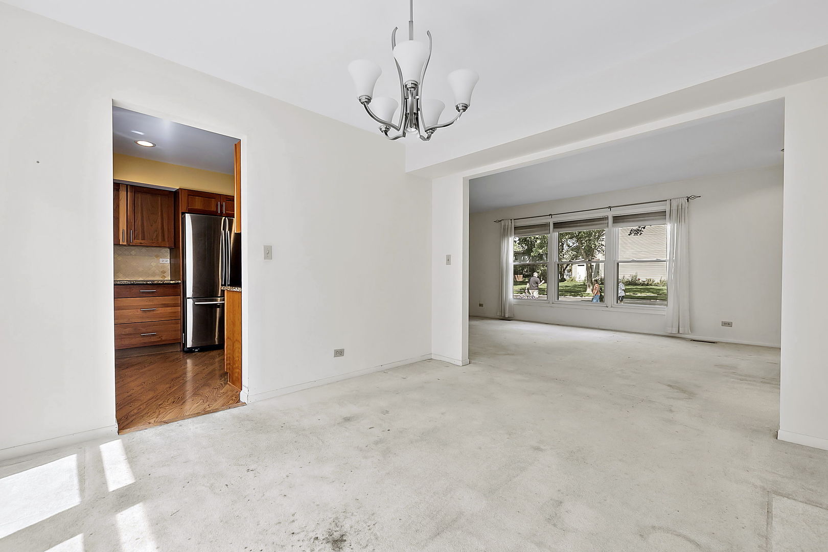 2080 Springside Drive Naperville, IL 60565 - Photo 10 of 31 en empty room with chandelier and glass door