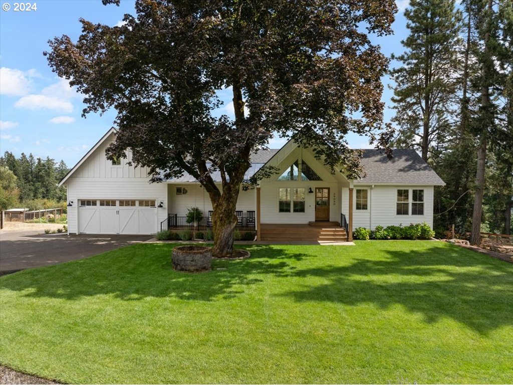 29050 Southwest Petes Mountain Road West Linn, OR 97068 - Photo 1 of 48 a front view of a house with a garden and trees