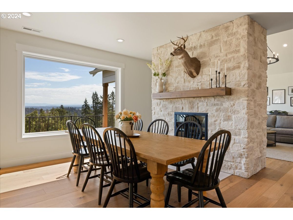 29050 Southwest Petes Mountain Road West Linn, OR 97068 - Photo 17 of 48 a view of a dining room with furniture and a floor to ceiling window