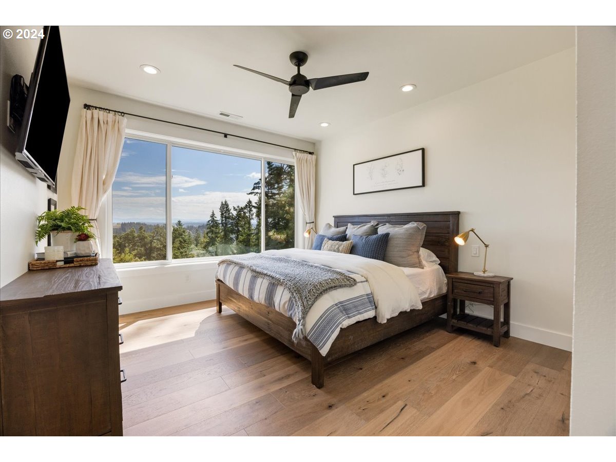 29050 Southwest Petes Mountain Road West Linn, OR 97068 - Photo 22 of 48 a bedroom with a bed mirror and window
