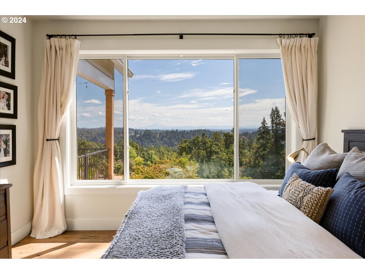 29050 Southwest Petes Mountain Road West Linn, OR 97068 - Photo 23 of 48 a living room filled with furniture and a floor to ceiling window