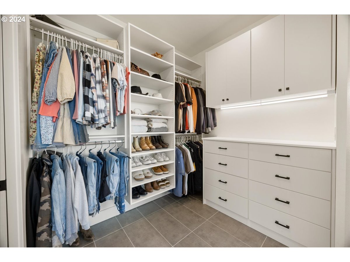 29050 Southwest Petes Mountain Road West Linn, OR 97068 - Photo 24 of 48 a view of walk in closet with clothes and shoes