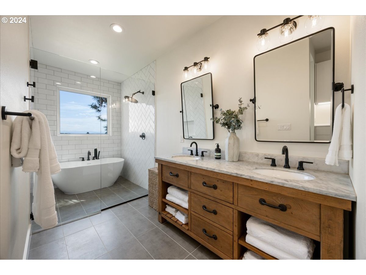 29050 Southwest Petes Mountain Road West Linn, OR 97068 - Photo 25 of 48 a bathroom with a double vanity sink tub double and mirror