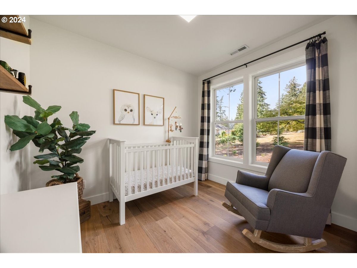 29050 Southwest Petes Mountain Road West Linn, OR 97068 - Photo 27 of 48 a bedroom with furniture and a large window