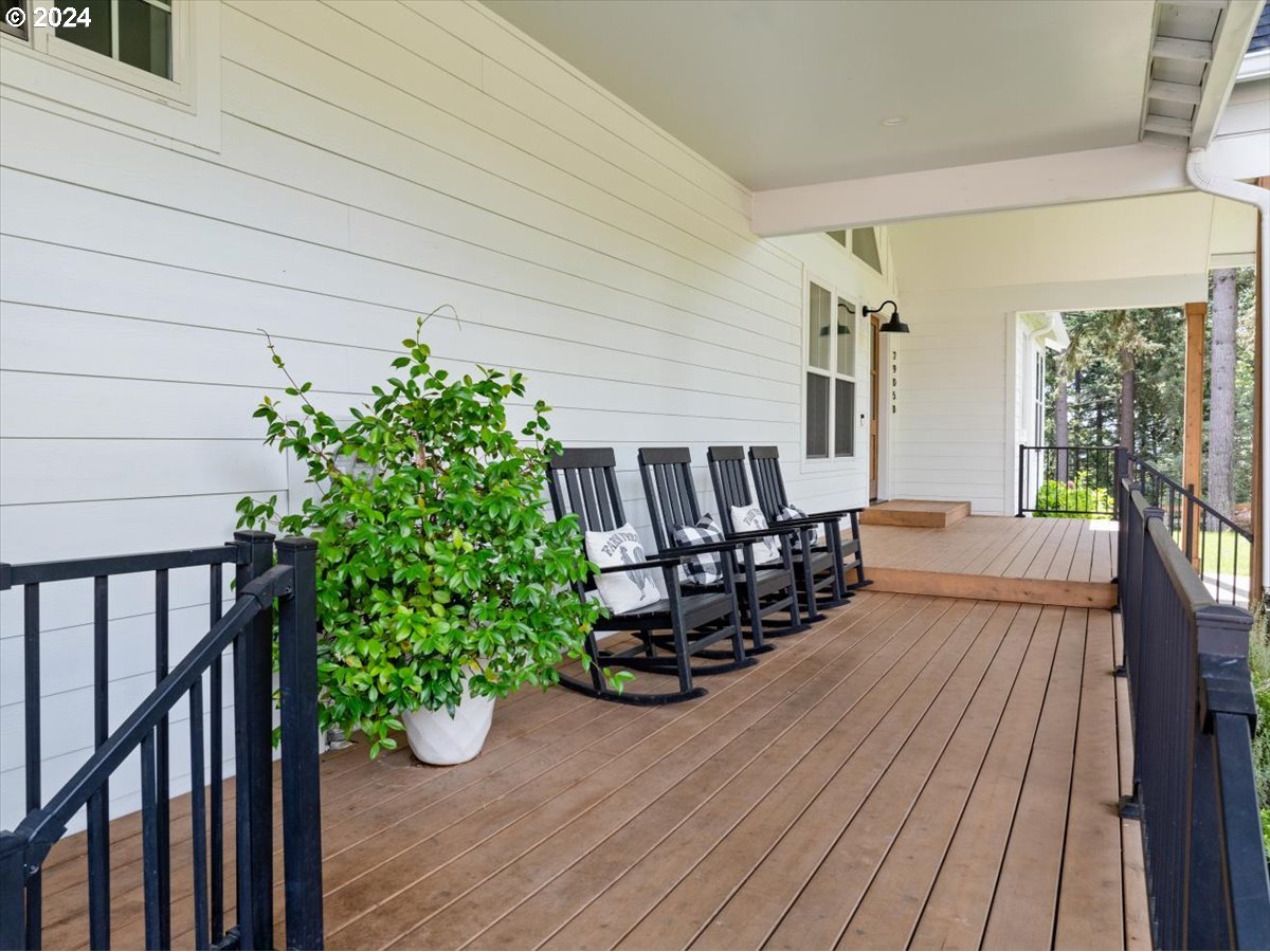 29050 Southwest Petes Mountain Road West Linn, OR 97068 - Photo 3 of 48 a view of a patio with table and chairs potted plants with wooden floor