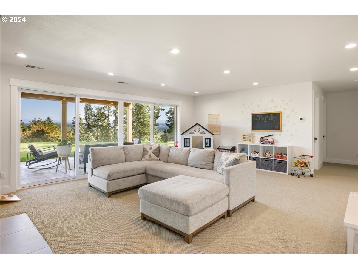 29050 Southwest Petes Mountain Road West Linn, OR 97068 - Photo 31 of 48 a living room with furniture and a flat screen tv