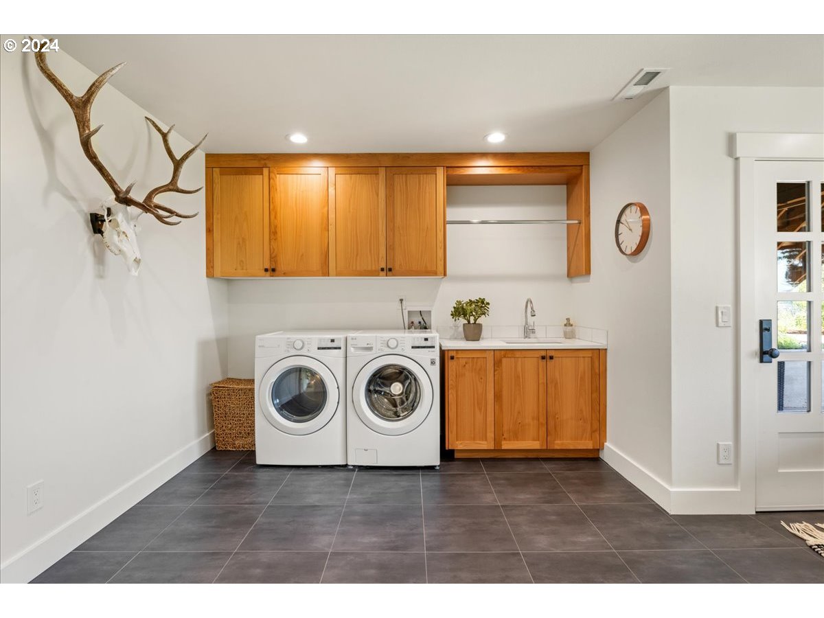 29050 Southwest Petes Mountain Road West Linn, OR 97068 - Photo 33 of 48 a view of a storage and utility room with washer and dryer