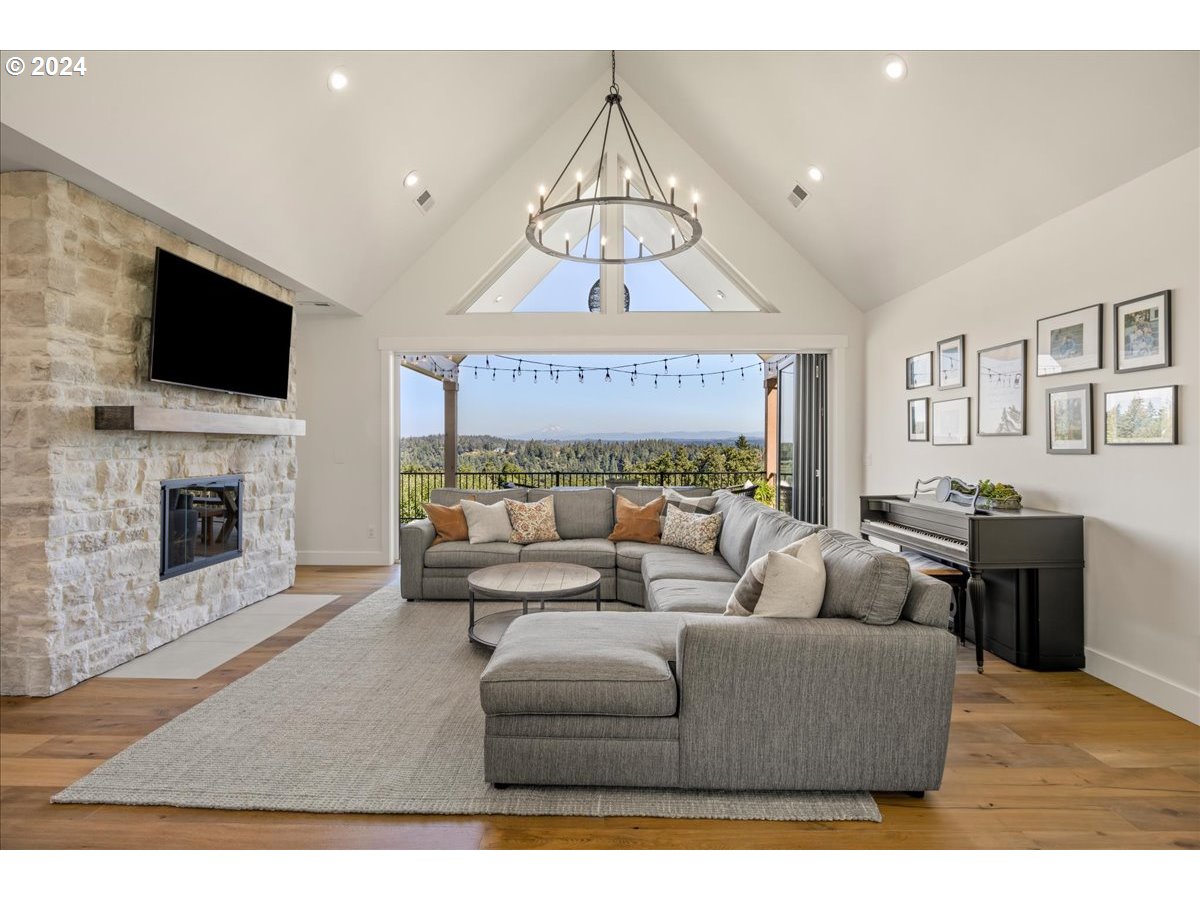 29050 Southwest Petes Mountain Road West Linn, OR 97068 - Photo 8 of 48 a living room with furniture a fireplace and a flat screen tv