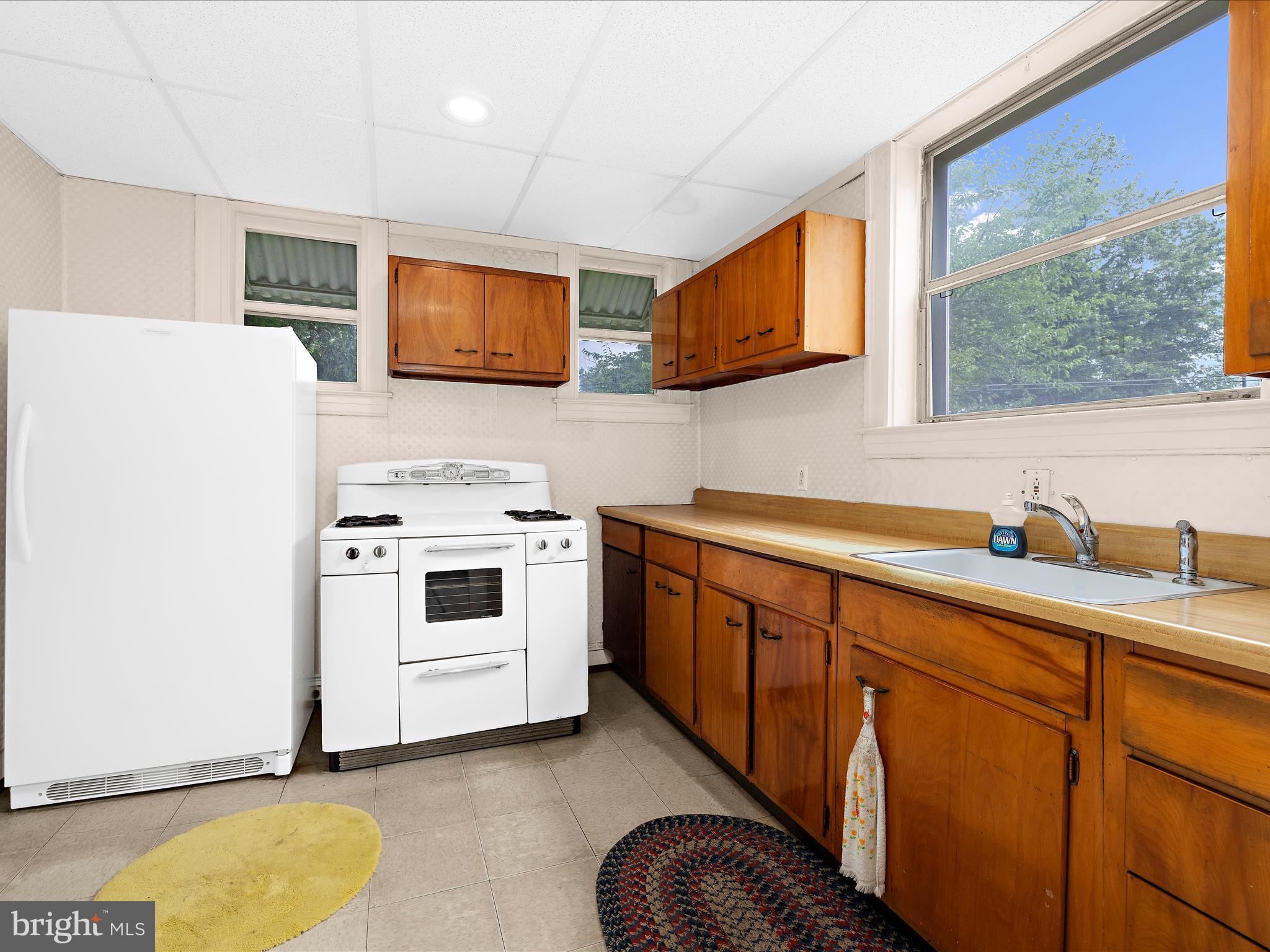 5000 Levindale Road Baltimore, MD 21215 - Photo 17 of 60 a kitchen with stainless steel appliances a stove a sink and a microwave
