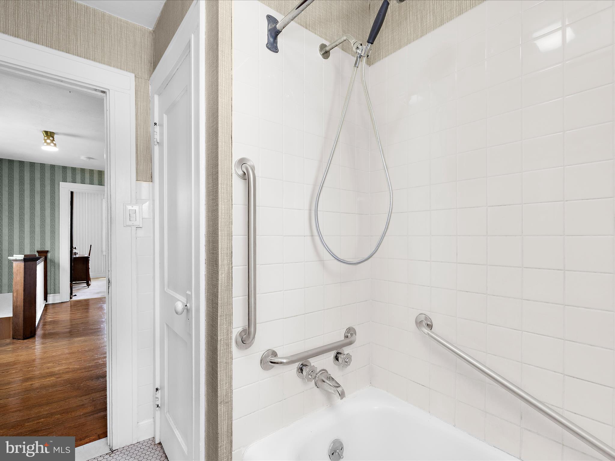 5000 Levindale Road Baltimore, MD 21215 - Photo 31 of 60 a bathroom with a sink a mirror and a shower