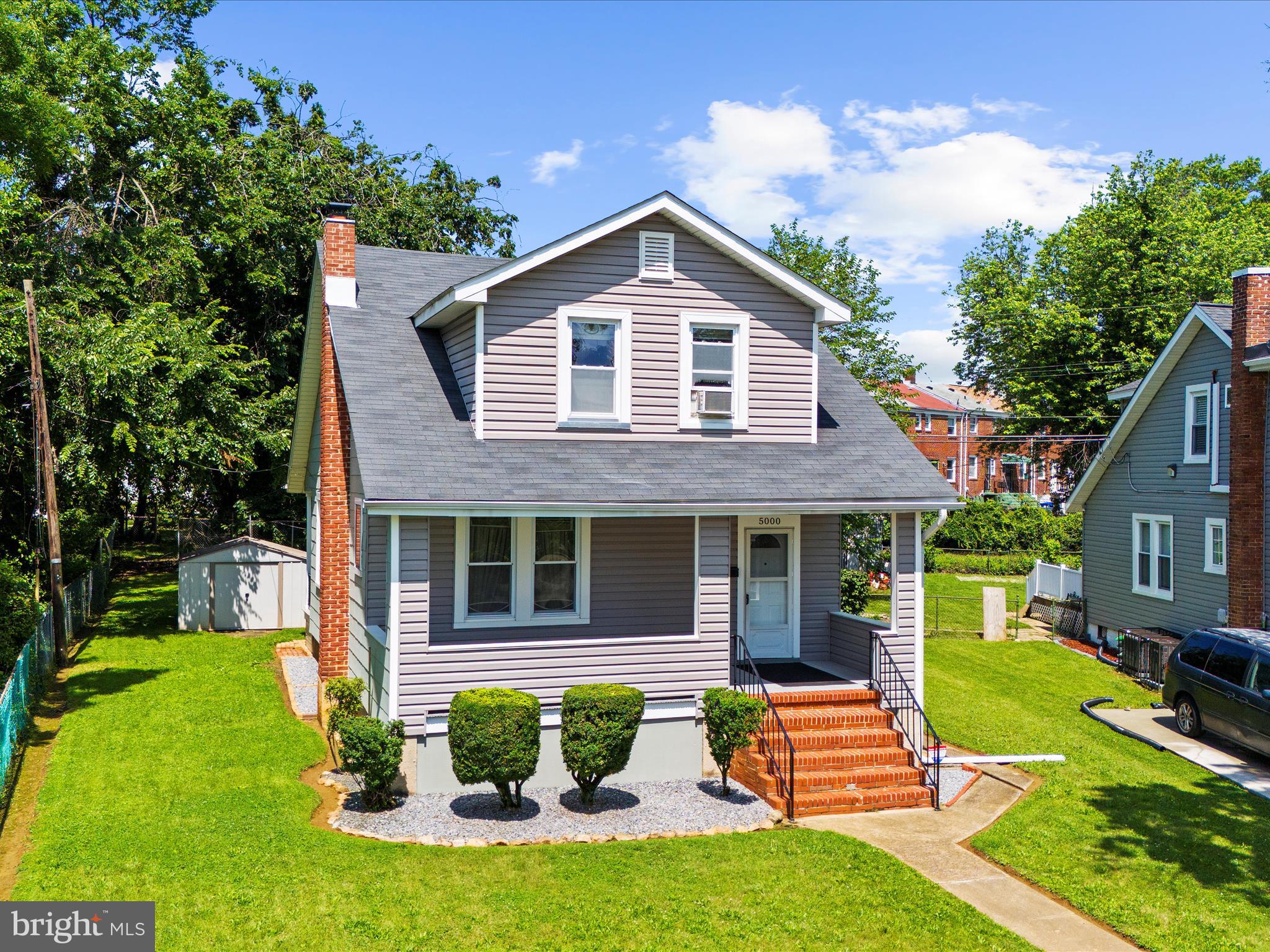 5000 Levindale Road Baltimore, MD 21215 - Photo 43 of 60 a front view of a house with a yard table and chairs