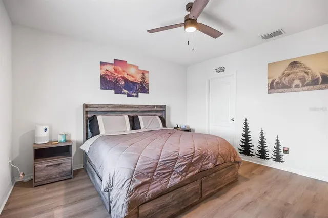 a bedroom with a large bed and a chandelier