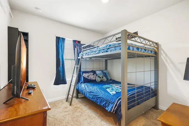 a bedroom with bed and a window