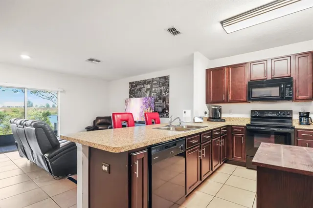 a kitchen with a stove a sink and a refrigerator