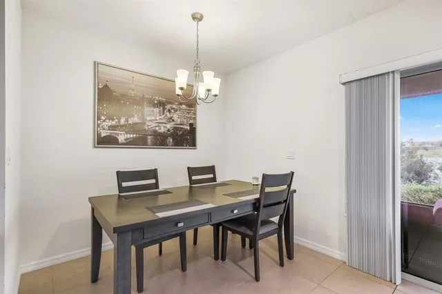 a view of a dining room with a table and chairs